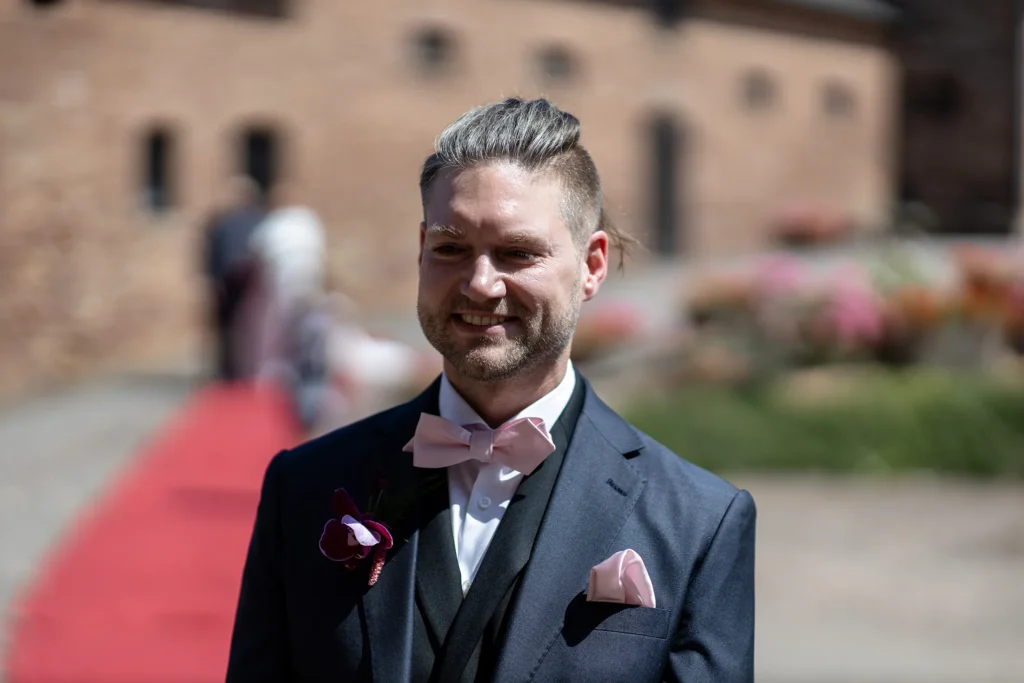 Hochzeitsfotograf Trier Luxemburg - Der freudestrahlende Bräutigam sieht beim First Look die Braut auf ihn zukommen.